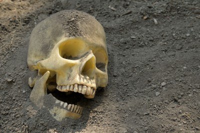 3616760-human-skull-half-buried-in-the-earth